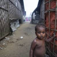 A Rohingya Muslim child stands outside a shelter at the Thet Kel Pyin camp in Myanmar\'s Rakhine state during the Eid al-Adha celebrations on Wednesday. | AFP-JIJI