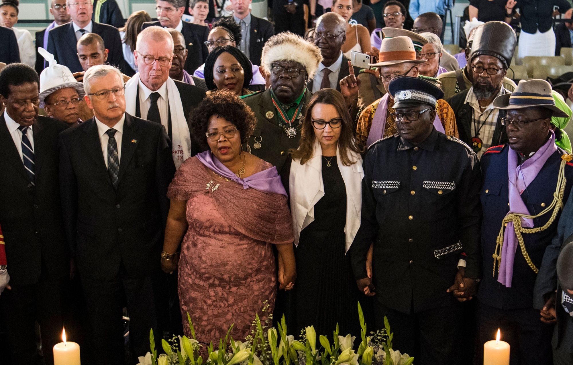 Namibian Culture Minister Katrina Hanse-Himarwa (third from left) and German Minister of State in the foreign ministry Michelle Muentefering (third from right) stand together during a handing-over ceremony for human remains that were brought to Berlin during its colonial rule of the African nation, on Wednesday in the French Church in Berlin. The skulls are among an estimated 300 taken to Germany after a massacre of indigenous Namibians at the start of the last century during an anti-colonial uprising in what was then called South West Africa, which Berlin ruled from 1884 to 1915. | JOHN MACDOUGALL / VIA AFP-JIJI