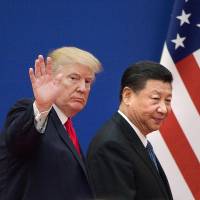 U.S. President Donald Trump and Chinese leader Xi Jinping leave a business leaders\' event at the Great Hall of the People in Beijing last November. | AFP-JIJI