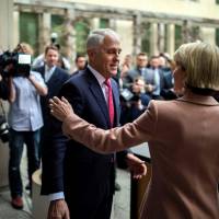 Australia\'s Prime Minister Malcolm Turnbull and Foreign Minister Julie Bishop leave after a news conference in Canberra on Tuesday. Turnbull narrowly survived a leadership challenge from within his own party on Tuesday as discontent with his rule boiled over less than a year before national elections. | AFP-JIJI