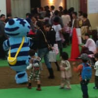 A gang of little people chase down the TDW mascot. | MIO YAMADA PHOTO