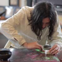 Artist and fashion designer Akiyoshi Mishima at work on the Red Bull Curate Canvas Cooler project. (Photo by Hiro Ikematsu) | PHOTO BY HIRO IKEMATSU