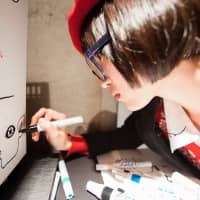 Artist Haraguro Picasso draws on a canvas cooler at SuperDeluxe. (Photo by Michael Holmes) | PHOTO BY HIRO IKEMATSU