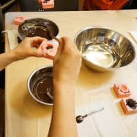 Filling the molds with chocolate. Photo courtesy of FabCafe | VIETNAM NEWS AGENCY / VIA AFP-JIJI