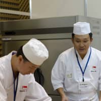 At The World International Sushi Cup Japan 2013, the Singaporean team rolls together. | VIETNAM NEWS AGENCY / VIA AFP-JIJI