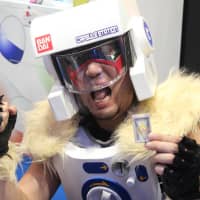 A man costumed in vending machine attire demonstrates new Bondai products. | AP