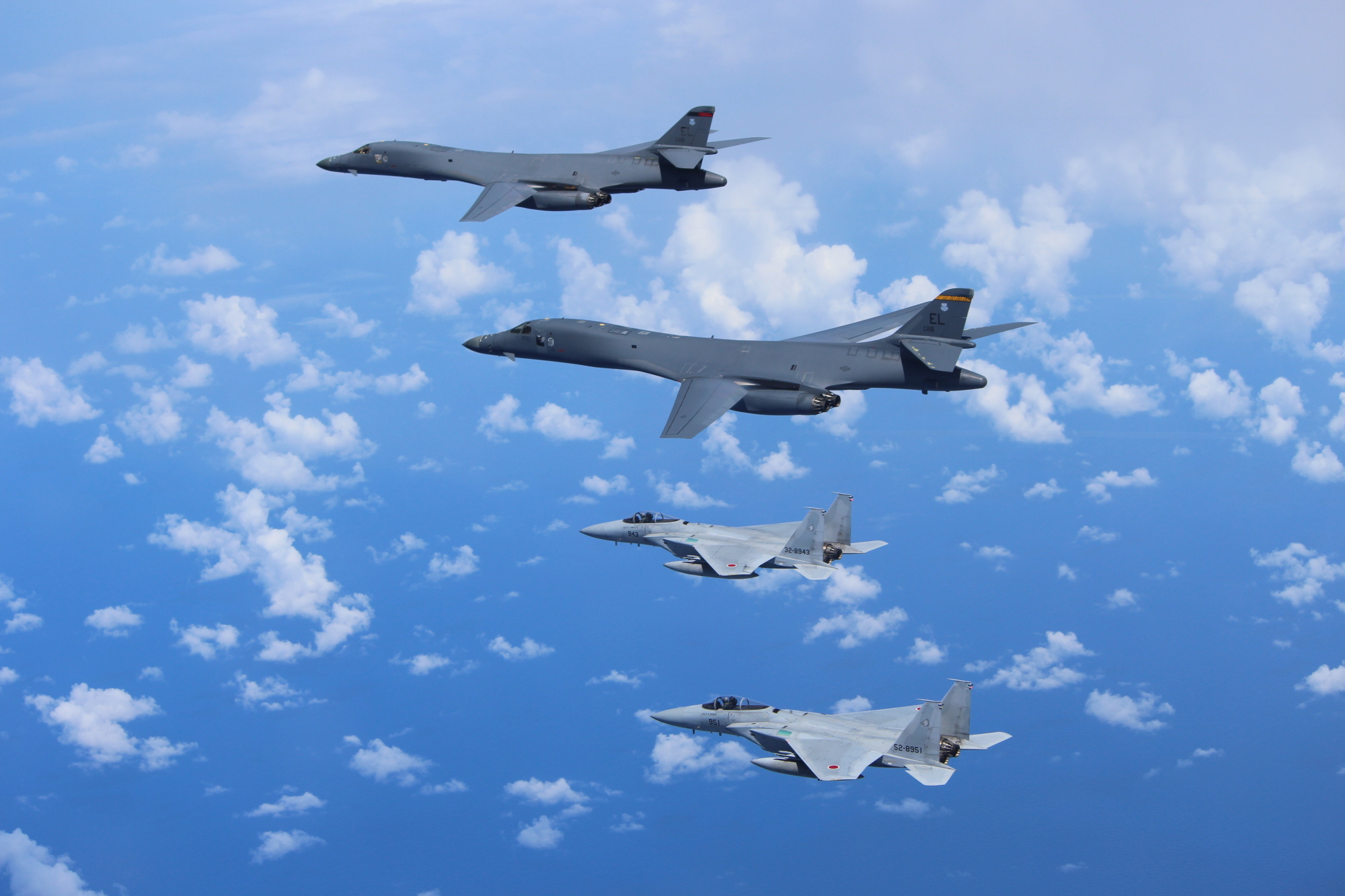 Two Air Self-Defense Force F-15 fighter jets fly alongside two U.S. Air Force B-1B bombers over the vicinity of the East China Sea in September last year. | U.S. PACIFIC AIR FORCES