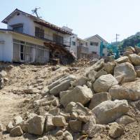 Devastated houses are shown Sunday in Kuchita, a part of Hiroshima\'s Asakita Ward that hosts a large population of foreign residents. | MAGDALENA OSUMI