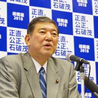 Former Defense Minister Shigeru Ishiba speaks at a news conference in Tokyo on Friday. Ishiba said the ruling Liberal Democratic Party should not rush on revising the Constitution. | REIJI YOSHIDA