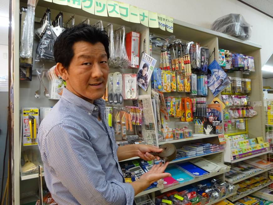 Hiroo Urakami shows a teapot designed for lefties at his stationery store in Sagamihara, Kanagawa Prefecture.