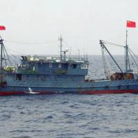 A Chinese fishing vessel is seen near the disputed Senkaku Islands last August. | THE JAPAN COAST GUARD / VIA KYODO