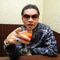 So Kuramoto, head of Takakura-gumi, scowls with a glass of tomato juice in hand at a cafe in Tokyo\'s Shinjuku Ward on Aug. 2. | ALEX MARTIN