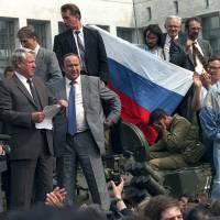 Russian President Boris Yeltsin (foreground left) addresses the crowd from atop a tank in Moscow during an attempted coup on Aug. 19, 1991 | AP