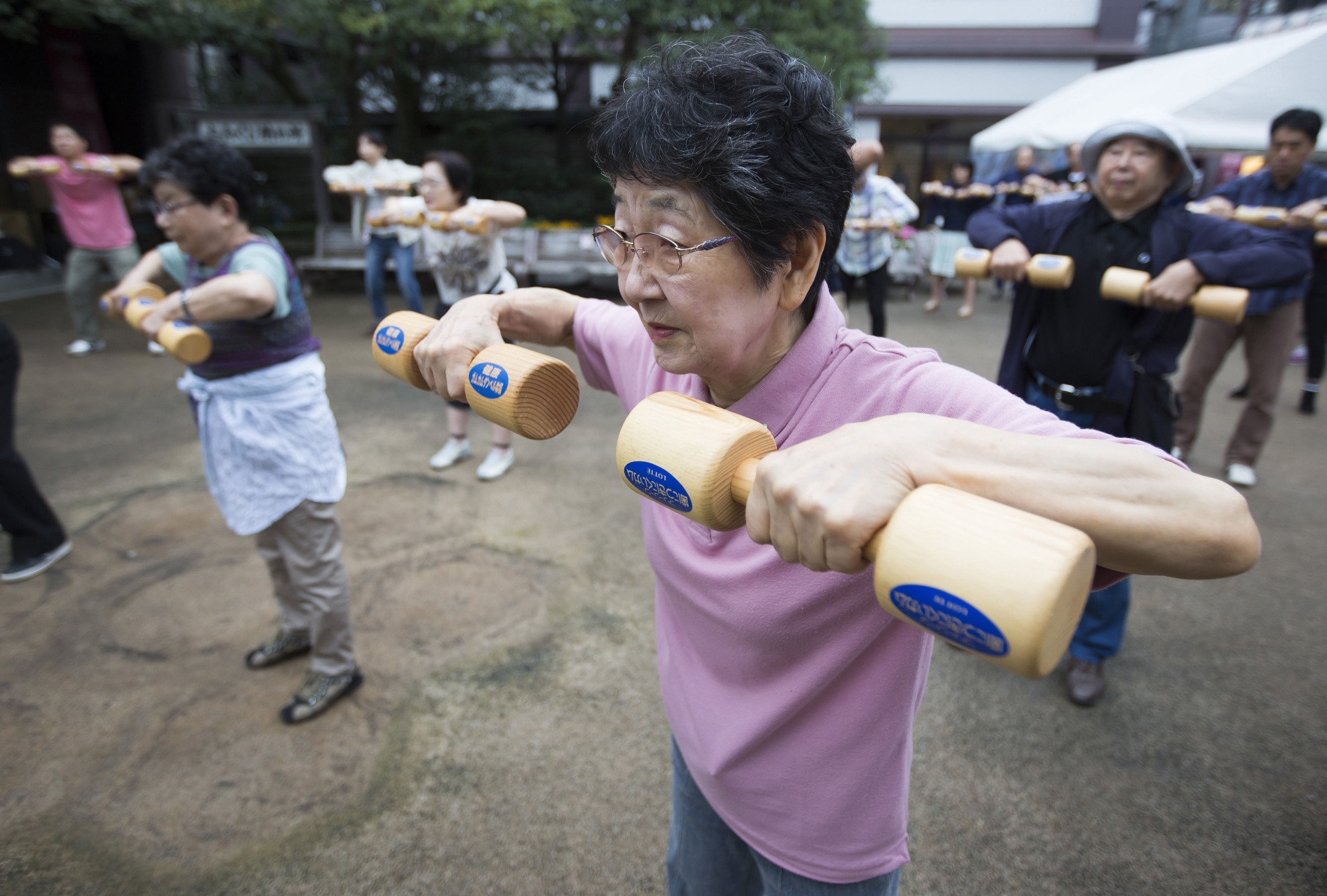 As old as you feel: A woman exercises at an event marking Respect for the Aged Day at a temple in Tokyo. This year the day falls on Sept. 17. | BLOOMBERG