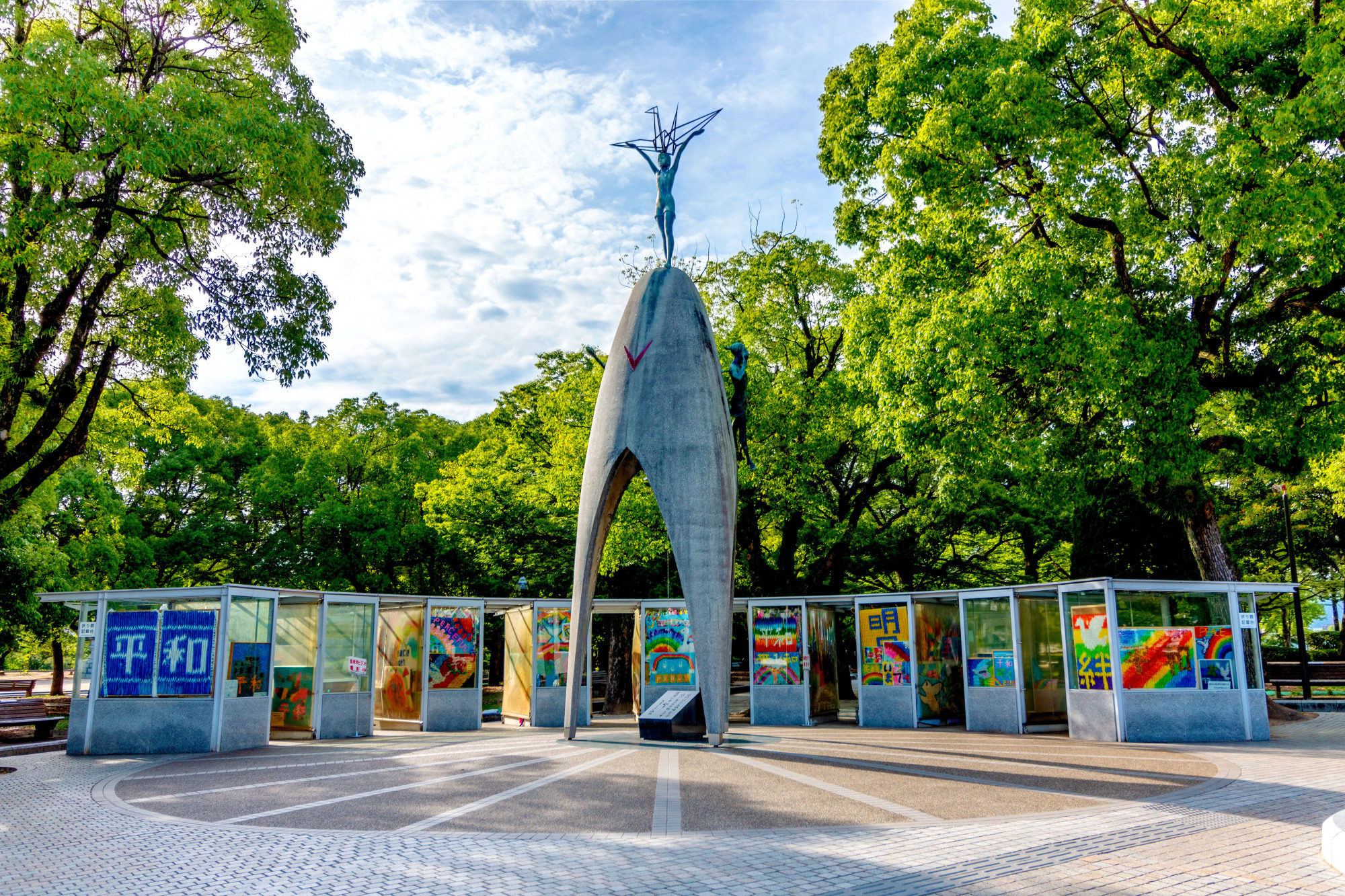 Left: The Children's Peace Monument, topped by the figure of Sadako Sasaki, is surrounded by paper cranes donated to Hiroshima's Peace Memorial Park from around the world. The nine booths surrounding the monument were installed by the city in 2002 to protect the cranes. | PETER CHORDAS