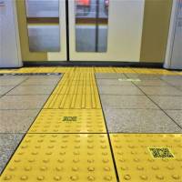 Mind the gap: With these QR-coded stickers, visually impaired rail users just need to point their phones to the floor when they hit the bumps to receive verbal warnings of what\'s ahead. | KYODO