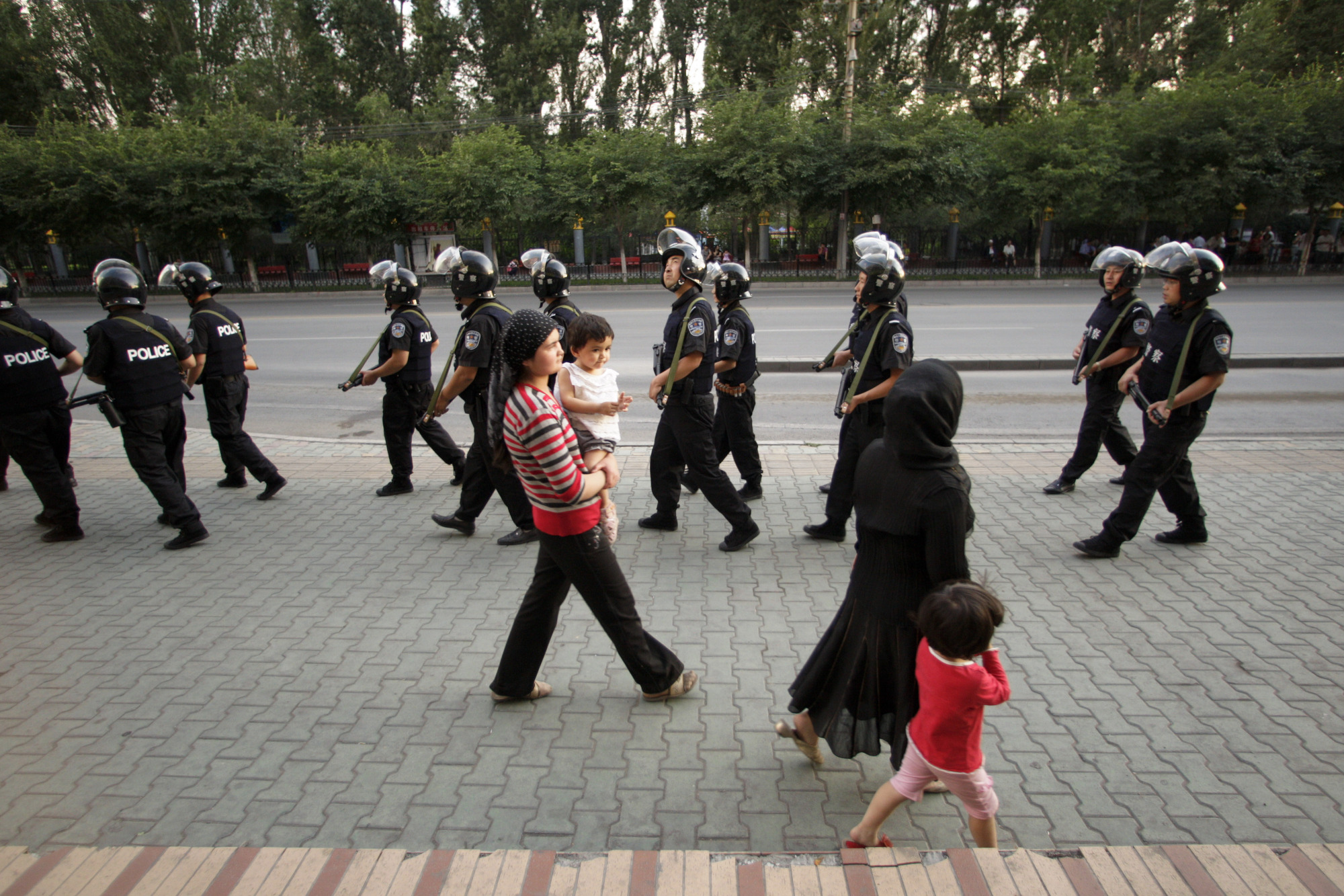 Paramilitary police patrol a Uighur neighborhood in Urumqi, Xinjiang province, China, in July 2009. | BLOOMBERG NEWS
