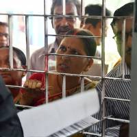 A woman whose name was left off the National Register of Citizens draft tries to file an appeal in Guwahati in the northeastern Indian state of Assam on Aug. 11. Around 4 million people in Assam were not included in the draft list, sparking  fears of deportation for large numbers of Muslims. | AFP-JIJI