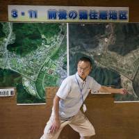 Kamaishi Higashi Junior High School Principal Kenji Sasaki explains the damage caused by the tsunami that follwed the 2011 Great East Japan Earthquake. | AFP-JIJI