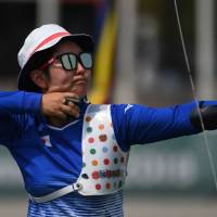 Tomomi Sugimoto fires an arrow during the mixed recurve archery final against North Korea at the Asian Games in Jakarta on Monday. | AFP-JIJI