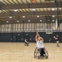 Japan wheelchair basketball guard Takahiro Akeda shoots during a national team practice session in July at Para Arena. Akeda trains at the facility three days a week. | YOSHIAKI MIURA