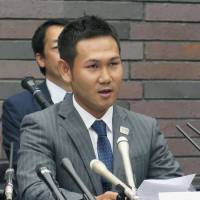 Boxer Katsunari Takayama speaks at a news conference in Osaka on Monday. | KYODO