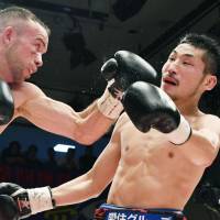 TJ \"The Power\" Doheny (left) punches Ryosuke Iwasa in the 11th round of their IBF super bantamweight title fight on Thursday at Korakuen Hall. Doheny beat the champion by unanimous decision. | KYODO