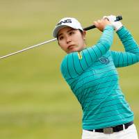 Mamiko Higa watches her shot from the fairway at the Women\'s British Open on Friday at Royal Lytham &amp; St. Annes. Higa carded a 69 and is one shot off the pace. | ACTION IMAGES VIA REUTERS
