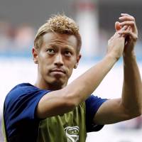 Keisuke Honda acknowledges fans following Japan\'s match against Poland during the 2018 World Cup on June 28. | REUTERS