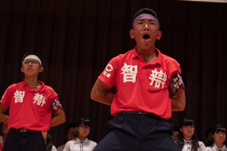 Students lead cheers during a pep rally before the tournament. 