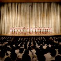 The team stands on stage during a pep rally before leaving for Koshien. | LANCE HENDERSTEIN