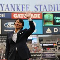 Former New York Yankees outfielder Hideki Matsui waves to fans during a pregame ceremony commemorating his induction into the Japanese Hall of Fame on Monday at Yankee Stadium. | ANDY MARLIN / USA TODAY / VIA REUTERS