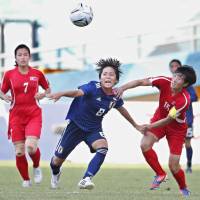 Japan\'s Mana Iwabuchi (center) looks to control the ball against North Korea in the Asian Games women\'s soccer tournament quarterfinals on Saturday in Palembang, Indonesia. Iwabuchi scored the first goal of the match, which Japan won 2-1. | KYODO