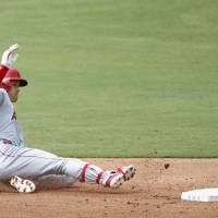 Shohei Ohtani slides into second base during the Los Angeles Angels\' game against the Texas Rangers on Sunday. | KYODO