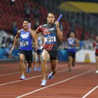 Japan\'s Asuka Cambridge crosses the finish line first in the men\'s 4x100-meter relay at the Asian Games on Thursday in Jakarta. Japan won the event for the first time in 20 years at the Asian Games. | AP
