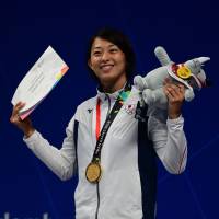 Satomi Suzuki, seen celebrating after winning the women\'s 50-meter breaststroke final on Thursday at the Asian Games in Jakarta, collected three golds at the marquee meet. | AFP-JIJI
