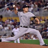 New York\'s Masahiro Tanaka pitches during the Yankees\' 2-1 win over the Marlins in Miami on Tuesday. | USA TODAY / VIA REUTERS