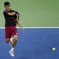 Kei Nishikori plays a shot from Gael Monfils in their second-round match at the U.S. Open on Thursday. | AP