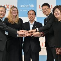 From left: Ken Hayami, executive director of the Japan Committee for UNICEF; Shanelle Hall, deputy executive director of UNICEF New York\'s headquarters; Hiroto Izumi, special adviser to the prime minister; Kinya Seto, president and CEO of Lixil Group Corp.; and Jin Song Montesano, executive officer and senior managing director of LIXIL Group Corp. pose for a photo at a news conference announcing a partnership between UNICEF and Lixil Corp. to work together to address sanitation problems around the world at Showa Women\'s University, Tokyo, on July 26. | YOSHIAKI MIURA