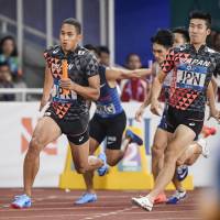 Japan\'s Asuka Cambridge (left) runs the final leg of the men\'s 4x100-meter relay at the Asian Games on Thursday in Jakarta. Japan captured the gold medal in 38.16 seconds, claiming the Asiad title for the first time in 20 years. | KYODO