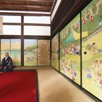 A Buddhist monk at Daitokuji Temple in Kyoto sits in a room with fusuma sliding doors bearing the works of popular cartoonist Kenichi Kitami nearly a week ahead of its public opening on Saturday. The characters are from Kitami\'s \"Tsuribaka Nisshi\" comic series based on the lives of salarymen who are avid fishermen. | KYODO