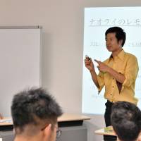 Miyake speaks about using fresh organic lemon juice for Naorai\'s Mikado Lemon sparkling sake during his presentation on July 30 in Tokyo. | YOSHIAKI MIURA