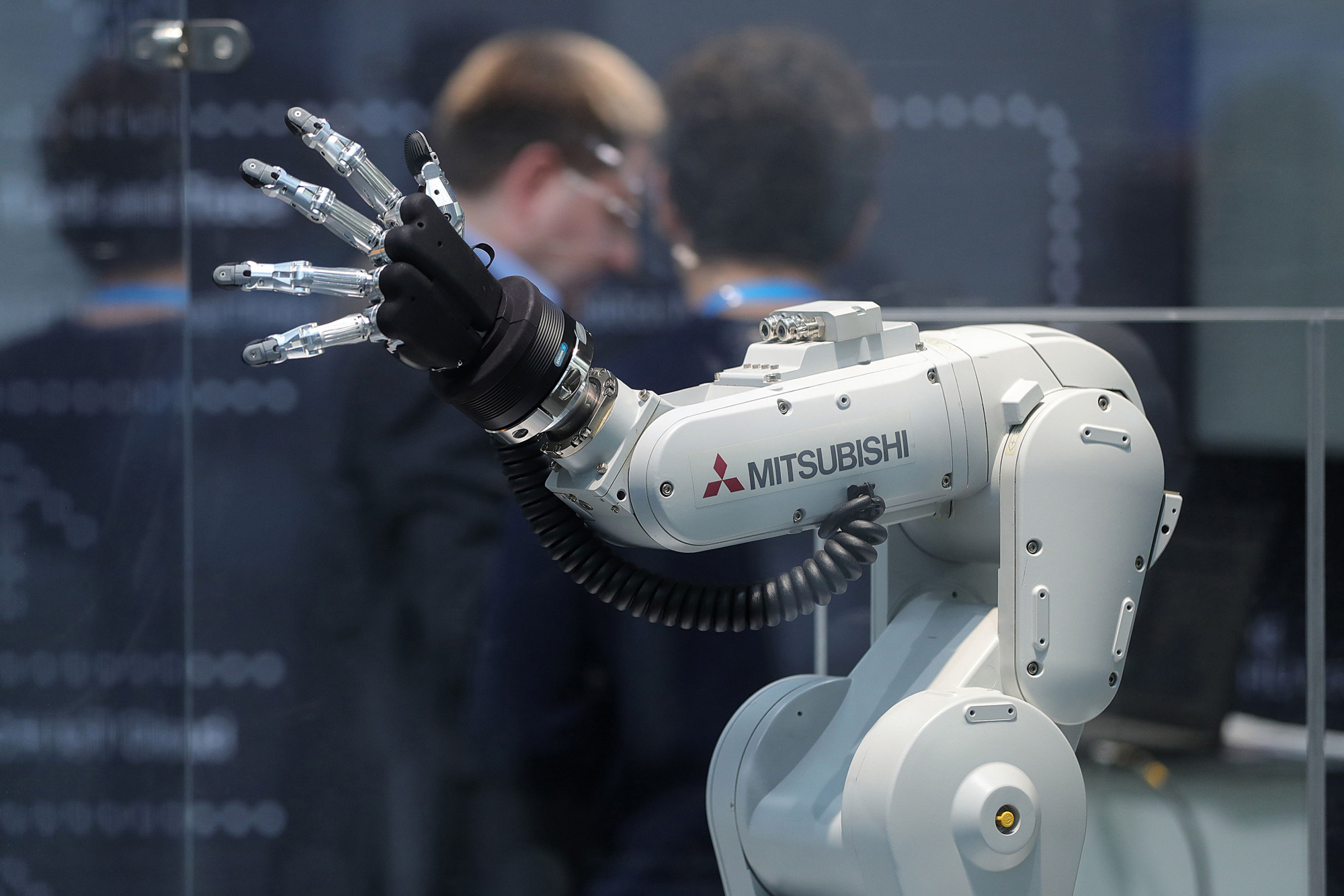 A Mitsubishi Melfa robotic arm, manufactured by Mitsubishi Electric Corp., is displayed at the Robert Bosch GmbH Internet of Things conference in Berlin in February. | BLOOMBERG