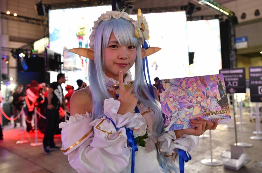 A cosplayer greets visitors at the Tokyo Game Show at Makuhari Messe in Chiba Prefecture on Thursday.