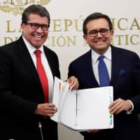 Mexican Economy Minister Ildefonso Guajardo delivers a summary of NAFTA negotiations to Sen. Ricardo Monreal during a meeting with other senators in Mexico City on Friday. | REUTERS