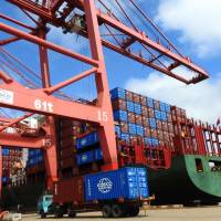 A truck transporting containers at a port in Lianyungang in China\'s eastern Jiangsu province on July 13. | AFP-JIJI