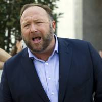 Conspiracy theorist Alex Jones speaks Wednesday outside of the Dirksen building of Capitol Hill after listening to Facebook COO Sheryl Sandberg and Twitter CEO Jack Dorsey testify before the Senate Intelligence Committee on \'Foreign Influence Operations and Their Use of Social Media Platforms\' on Capitol Hill in Washington. Twitter is permanently banning right-wing conspiracy theorist Jones and his \"Infowars\" show for abusive behavior. | AP