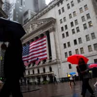 Pedestrians walk in front of the New York Stock Exchange in New York on Sept. 10. | BLOOMBERG