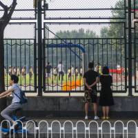 People watch a ceremony marking the start of the school year at a school in Beijing on Sept. 1. | ZHAO RONG/QIANLONG.COM / VIA REUTERS