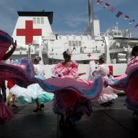 Members of the Chinese People Liberation Army Navy stand at its Peace Ark hospital ship during its arrival ceremony at the port in La Guaira, Venezuela, on Saturday. | REUTERS